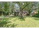 A well-maintained lawn and mature trees surround the exterior of this inviting brick home at 5315 Camden St, Indianapolis, IN 46227