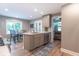 Bright kitchen with a large window, stainless steel appliances, gray cabinets, and a marble countertop island at 5315 Camden St, Indianapolis, IN 46227