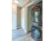 Efficient laundry room with stacked washer and dryer, storage cabinets, and neutral-toned flooring at 5315 Camden St, Indianapolis, IN 46227