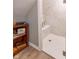 Bright bathroom shower featuring white marble tiling and a frameless glass door at 5315 Camden St, Indianapolis, IN 46227