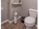 Bathroom toilet with a wooden-style floor and a toilet paper holder next to the fixture at 5315 Camden St, Indianapolis, IN 46227