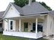 Charming front porch with white columns, a brick base, and a cozy seating area at 554 W Taylor St, Shelbyville, IN 46176