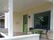 Inviting front porch with seating, a green door, and ample natural light at 554 W Taylor St, Shelbyville, IN 46176