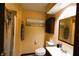 This bathroom features a vanity with a sink, a toilet, a cabinet, and a shower with a curtain at 5654 Paradise Dr, Martinsville, IN 46151