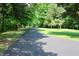 Long private driveway winds through a lush green landscape, offering seclusion and natural beauty at 5654 Paradise Dr, Martinsville, IN 46151