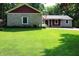 Charming home featuring stone accents, red siding, and a well-manicured front lawn at 5654 Paradise Dr, Martinsville, IN 46151