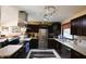 Well-appointed kitchen with dark cabinets, stainless steel appliances, and granite countertops at 5654 Paradise Dr, Martinsville, IN 46151