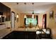 An open kitchen with dark cabinets, granite countertops, and a view of the dining area at 5654 Paradise Dr, Martinsville, IN 46151