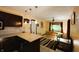 An open concept kitchen with dark cabinets, light countertops, and view into the dining area at 5654 Paradise Dr, Martinsville, IN 46151