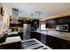 Modern kitchen featuring stainless steel appliances, dark cabinetry, and a stylish backsplash at 5654 Paradise Dr, Martinsville, IN 46151