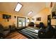 Spacious living room with vaulted ceiling, skylights, access to the backyard, and hardwood flooring at 5654 Paradise Dr, Martinsville, IN 46151