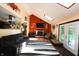 Comfortable living room with vaulted ceilings, skylight, fireplace, and access to the backyard at 5654 Paradise Dr, Martinsville, IN 46151