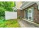 Backyard patio area featuring a sliding glass door and a white privacy fence at 5677 Brownstone Dr # 5677, Indianapolis, IN 46220
