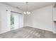 Bright dining room with sliding glass door and modern chandelier lighting at 5677 Brownstone Dr # 5677, Indianapolis, IN 46220