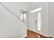 Bright foyer featuring wood floors, white trim, and a front door with sidelight windows at 5677 Brownstone Dr # 5677, Indianapolis, IN 46220