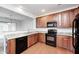 Modern kitchen with stainless steel appliances, granite countertops and wooden cabinets at 5677 Brownstone Dr # 5677, Indianapolis, IN 46220