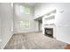 Spacious living room featuring large windows, neutral carpet, and a fireplace at 5677 Brownstone Dr # 5677, Indianapolis, IN 46220