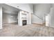 Bright living room showcasing a fireplace, staircase, and open layout at 5677 Brownstone Dr # 5677, Indianapolis, IN 46220