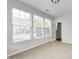 Light-filled sun room featuring tile flooring, multiple windows, and access to an adjacent space at 5677 Brownstone Dr # 5677, Indianapolis, IN 46220