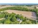 Aerial view of a white home surrounded by green trees and farmland at 5710 W 650 N, Thorntown, IN 46071