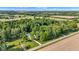 Aerial view of a home nestled among dense trees with expansive farmland in the distance at 5710 W 650 N, Thorntown, IN 46071