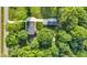 Aerial top-down view of the home with a detached garage surrounded by mature trees at 5710 W 650 N, Thorntown, IN 46071