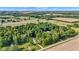 Aerial view of a rural property featuring lush trees and expansive farmland at 5710 W 650 N, Thorntown, IN 46071