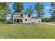 Back exterior view of a two-story home featuring a well-manicured backyard and a covered patio at 5710 W 650 N, Thorntown, IN 46071