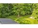 A large backyard with mature trees featuring a seating area with a fire pit at 5710 W 650 N, Thorntown, IN 46071