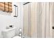 Clean bathroom featuring a toilet, patterned shower curtain, and stylish towel rack at 5710 W 650 N, Thorntown, IN 46071