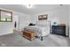 Calm bedroom with a bed, hardwood floors, artwork, and a window overlooking the backyard at 5710 W 650 N, Thorntown, IN 46071