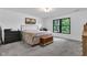 Neutral bedroom with a comfortable bed, a black dresser, and a view of the trees outside the window at 5710 W 650 N, Thorntown, IN 46071