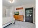 Well-lit bedroom with dresser, bookshelf, and a door with access to the landing at 5710 W 650 N, Thorntown, IN 46071