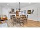 Open dining room with wooden table and chairs, fireplace, and view to living room at 5710 W 650 N, Thorntown, IN 46071