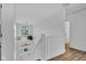 Bright entryway featuring white walls, a wooden floor, and a staircase leading down to the front door at 5710 W 650 N, Thorntown, IN 46071