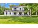 Exterior of the two-story home with a covered front porch, driveway, and well-manicured lawn at 5710 W 650 N, Thorntown, IN 46071