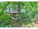 A-frame home in the woods with stairs leading to the elevated entrance at 5710 W 650 N, Thorntown, IN 46071
