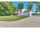 Exterior side view of a two-story home featuring a spacious yard and a concrete driveway at 5710 W 650 N, Thorntown, IN 46071