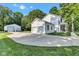 Side view of a charming home showcasing white siding, a concrete driveway, and a detached garage at 5710 W 650 N, Thorntown, IN 46071