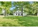 Charming two-story home with a sprawling green lawn surrounded by mature trees, offering a serene setting at 5710 W 650 N, Thorntown, IN 46071