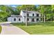 Exterior of the two-story home with a covered front porch, driveway, and well-manicured lawn at 5710 W 650 N, Thorntown, IN 46071