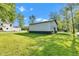 View of a home featuring a spacious backyard, detached garage, and lush surroundings at 5710 W 650 N, Thorntown, IN 46071