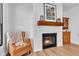 Cozy fireplace with wood mantle, shiplap wall, and comfortable armchair nearby at 5710 W 650 N, Thorntown, IN 46071