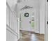Bright foyer with a decorative wreath on the front door, a staircase, and beautiful flooring creating a welcoming entry at 5710 W 650 N, Thorntown, IN 46071