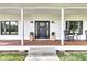 Inviting front porch featuring rocking chairs, decorative plants, and stylish lighting fixtures adding charm and character at 5710 W 650 N, Thorntown, IN 46071