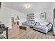Bright living room with modern gray sofa, wooden coffee table, and decor shelves at 5710 W 650 N, Thorntown, IN 46071