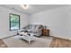 Cozy living room featuring a comfortable couch, a window with a backyard view, and neutral tones at 5710 W 650 N, Thorntown, IN 46071