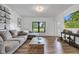 Bright living room with view to backyard, hardwood floor, comfortable sofa, large tv at 5710 W 650 N, Thorntown, IN 46071