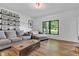 Cozy living room with sofa, decor shelves, wood-look floors, and bright windows at 5710 W 650 N, Thorntown, IN 46071
