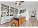 Spacious home office with built-in shelving, a vintage desk, and modern flooring creating a productive work environment at 5710 W 650 N, Thorntown, IN 46071